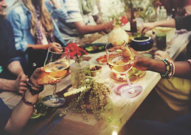 People enjoying food and drinks at a table