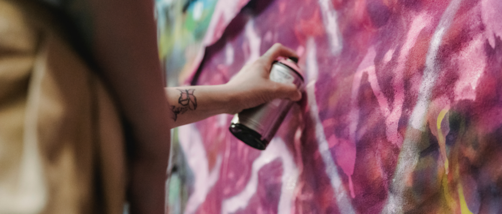 Close up view of person holding spray can